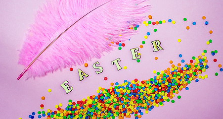 Image showing Abstract easter card with scattered color confectionery balls and letters. Easter holiday concept.