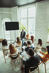 Image showing Male african-american speaker giving presentation in hall at university workshop