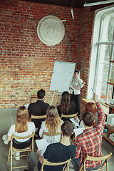 Image showing Female muslim speaker giving presentation in hall at university workshop