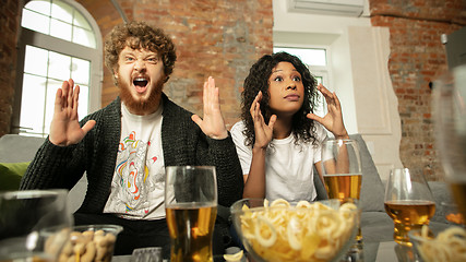 Image showing Excited couple, friends watching sport match, championship at home