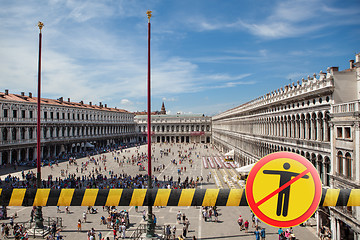 Image showing Prohibition yellow sign with crossed out man on the background of San Marco square in Venice, Italy.