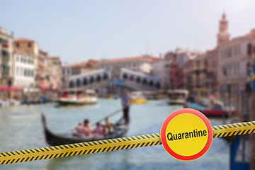 Image showing Prohibition sign of quarantine with a police line on a blurred background of Rialto Bridge in Venice, Italy.