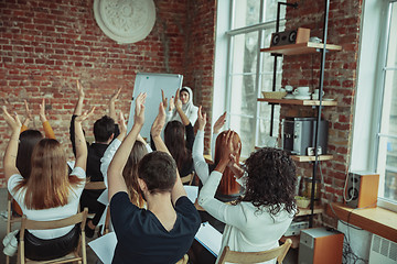 Image showing Female muslim speaker giving presentation in hall at university workshop