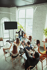 Image showing Male african-american speaker giving presentation in hall at university workshop