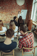 Image showing Female muslim speaker giving presentation in hall at university workshop