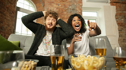 Image showing Excited couple, friends watching sport match, championship at home