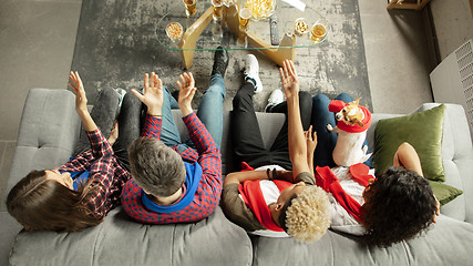 Image showing Excited group of people watching sport match, championship at home