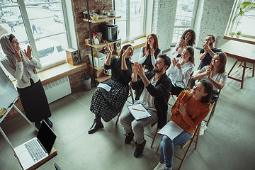 Image showing Female muslim speaker giving presentation in hall at university workshop