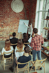 Image showing Female muslim speaker giving presentation in hall at university workshop