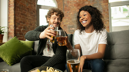 Image showing Excited couple, friends watching sport match, championship at home