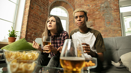 Image showing Excited couple, friends watching sport match, championship at home