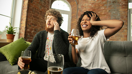 Image showing Excited couple, friends watching sport match, championship at home