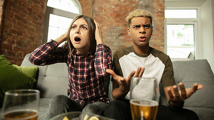 Image showing Excited couple, friends watching sport match, championship at home