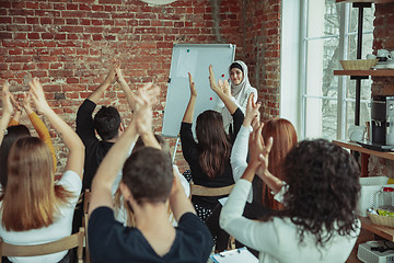 Image showing Female muslim speaker giving presentation in hall at university workshop