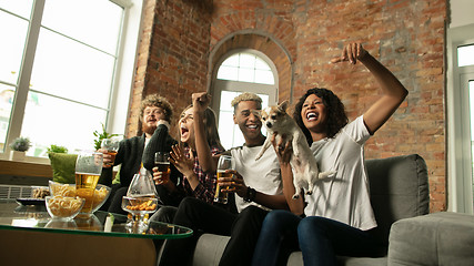 Image showing Excited group of people watching sport match, championship at home