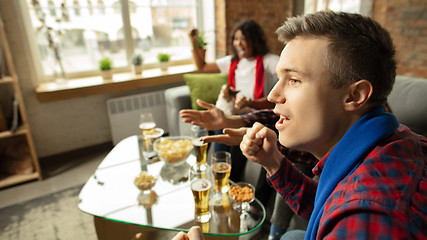 Image showing Excited group of people watching sport match, championship at home