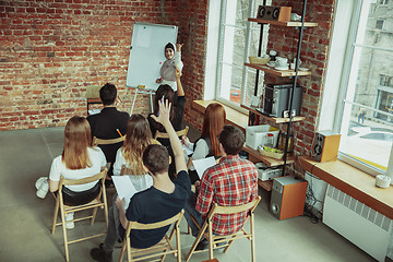 Image showing Female muslim speaker giving presentation in hall at university workshop