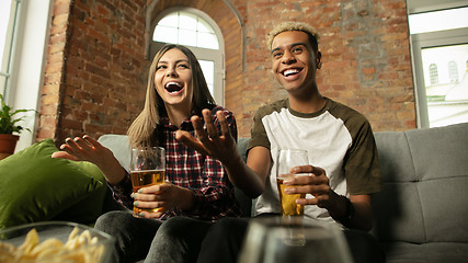 Image showing Excited couple, friends watching sport match, championship at home