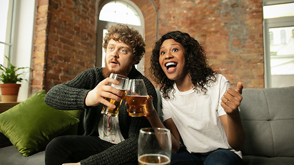 Image showing Excited couple, friends watching sport match, championship at home