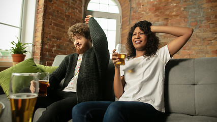 Image showing Excited couple, friends watching sport match, championship at home