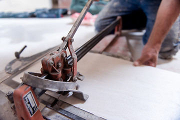 Image showing worker cutting the ceramic wood effect tiles