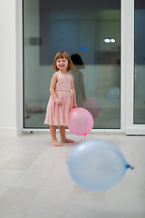 Image showing cute little girl playing with balloons