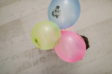 Image showing cute little girl playing with balloons