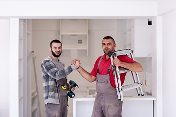 Image showing workers giving high five to each other