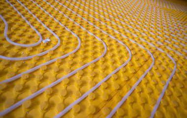 Image showing yellow underfloor heating installation with white pipes