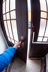 Image showing man opening door of a building