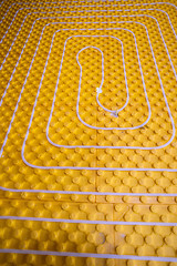 Image showing yellow underfloor heating installation with white pipes