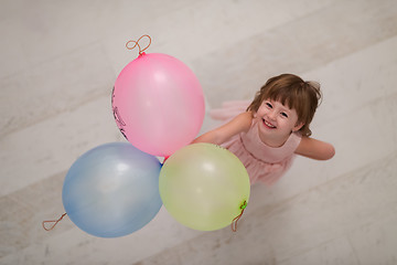 Image showing cute little girl playing with balloons