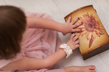 Image showing little girl enjoying while playing with mother\'s jewelry