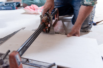 Image showing worker cutting the ceramic wood effect tiles