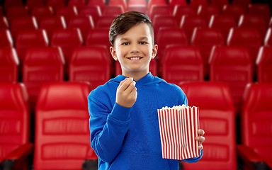 Image showing happy smiling boy eating popcorn at movie theater