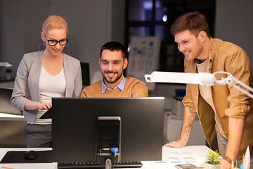 Image showing business team with computer working late at office