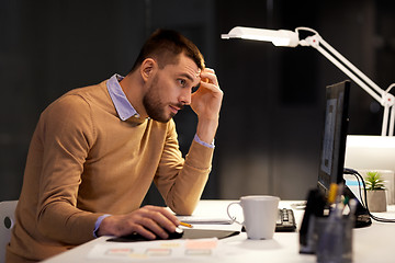 Image showing man with computer working late at night office