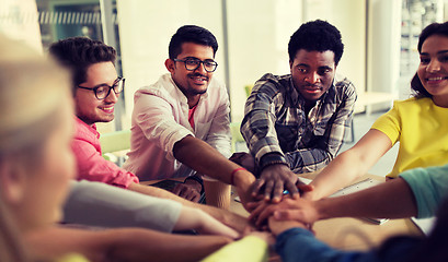 Image showing group of international students with hands on top