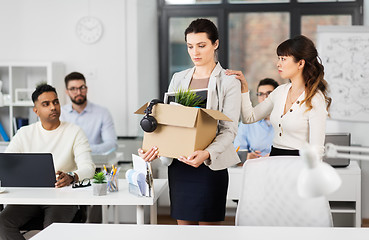 Image showing female office worker with box of personal stuff