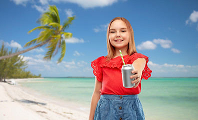 Image showing smiling preteen girl drinking soda from can