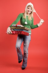 Image showing Caucasian girl carrying gifts on holiday