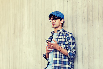 Image showing man with earphones and smartphone listening music