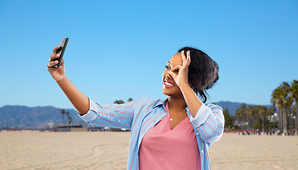 Image showing african american woman taking selfie by smartphone