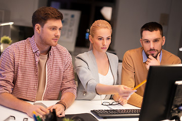 Image showing business team with computer working late at office