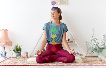 Image showing woman meditating in lotus pose at yoga studio