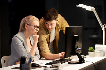 Image showing business team with computer at night office