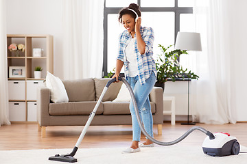 Image showing woman or housewife with vacuum cleaner at home