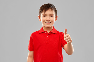 Image showing smiling boy in red t-shirt showing thumbs up