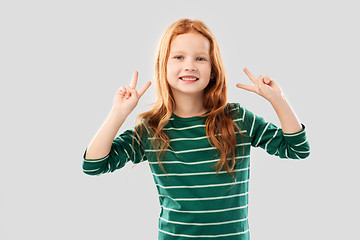 Image showing smiling red haired girl showing peace gesture