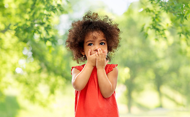 Image showing confused african american girl covering mouth